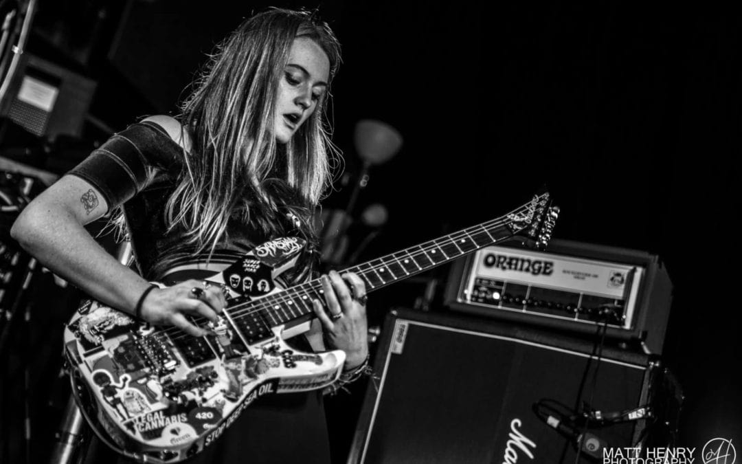 young woman on electric guitar