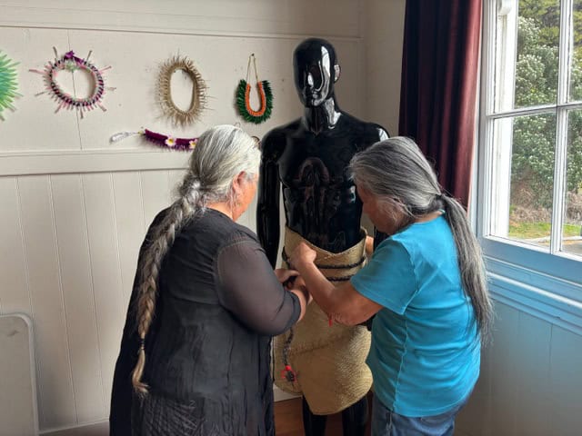 two elder women working on a costume