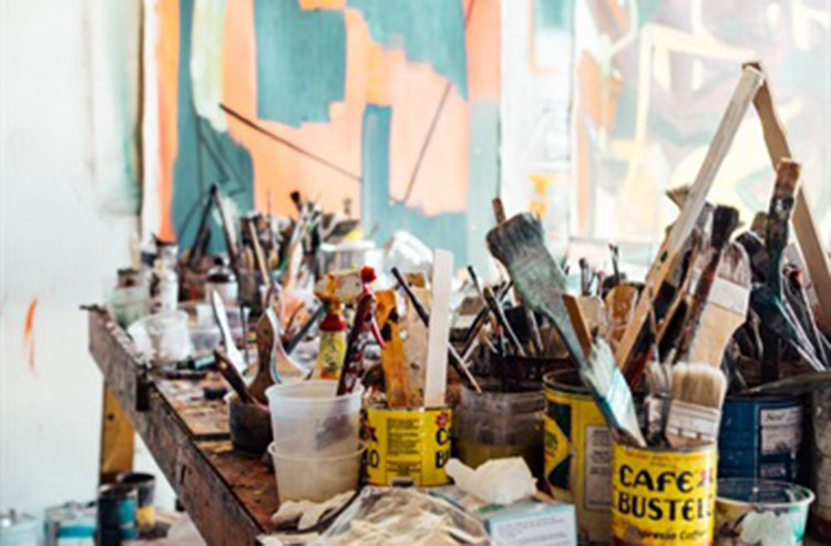 paint brushes in old tins